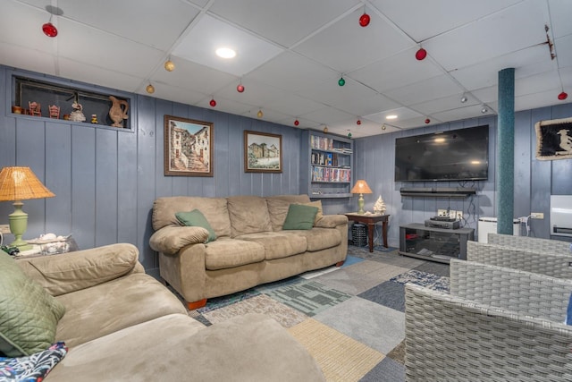 living room featuring a paneled ceiling