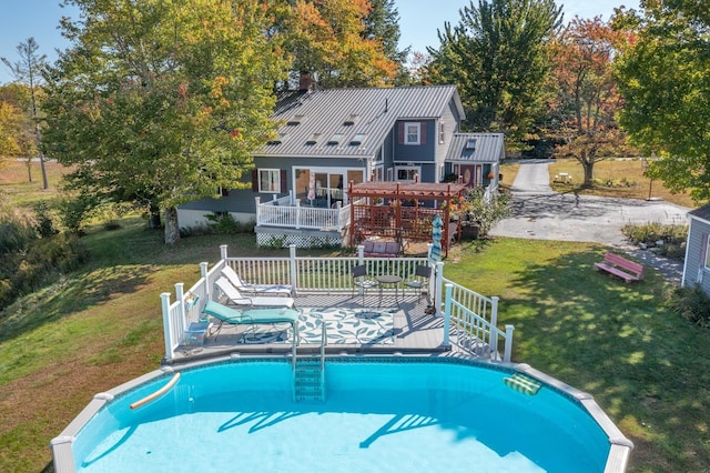 view of swimming pool featuring a pergola, a yard, a wooden deck, and a gazebo