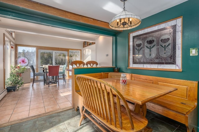 dining space with tile patterned flooring, an inviting chandelier, and beam ceiling