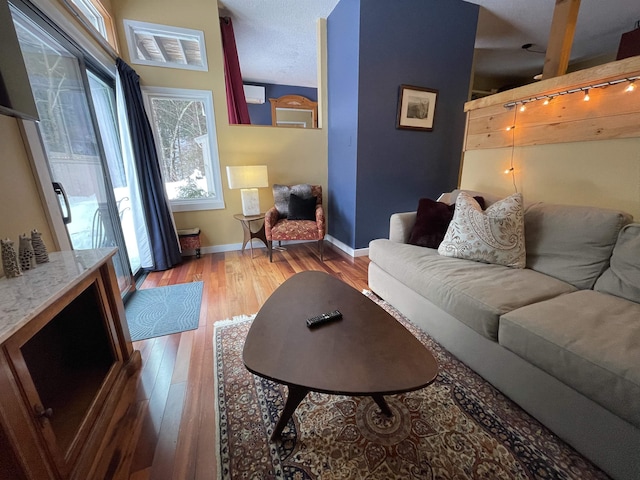 living room featuring wood-type flooring and lofted ceiling with beams