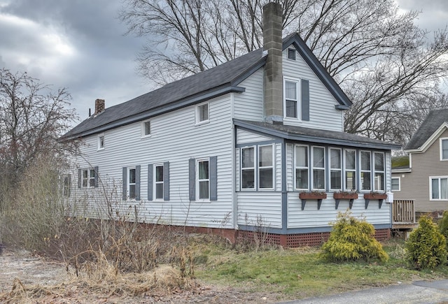 view of property exterior featuring a sunroom