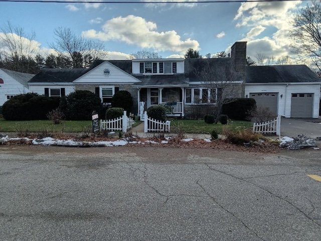 front of property with a garage and covered porch