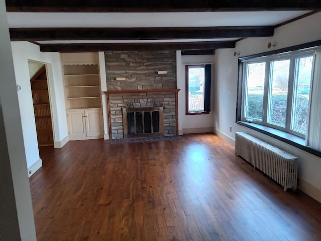 unfurnished living room featuring beam ceiling, radiator, a stone fireplace, and dark hardwood / wood-style floors