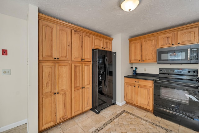 kitchen featuring light tile patterned flooring, a textured ceiling, and black appliances