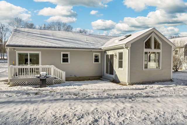 view of snow covered rear of property