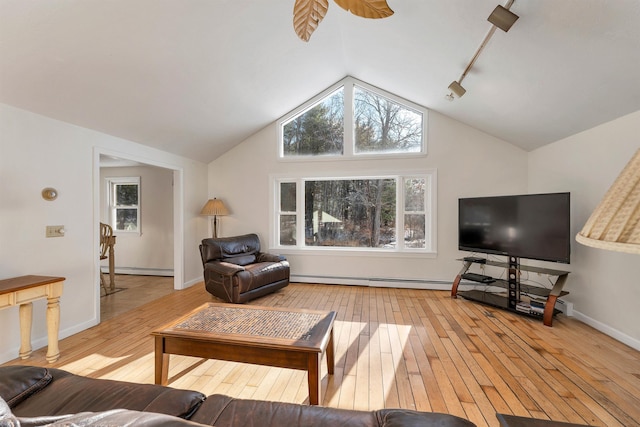 living room with track lighting, a baseboard radiator, light hardwood / wood-style flooring, and lofted ceiling