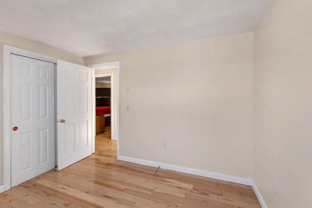 unfurnished bedroom with light wood-type flooring