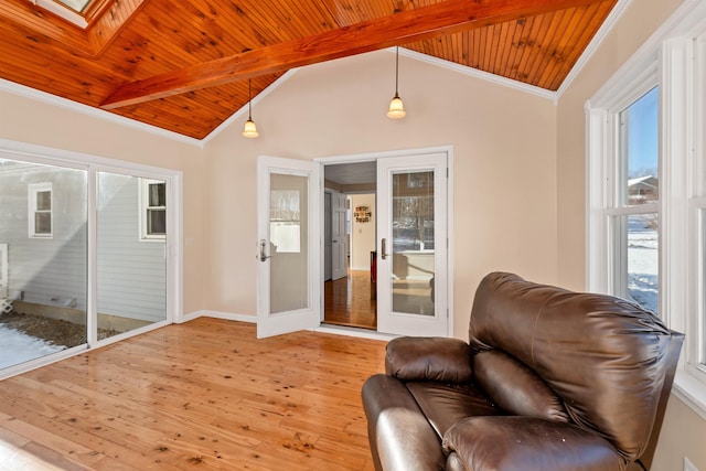 sitting room featuring french doors, crown molding, vaulted ceiling with skylight, wood ceiling, and light wood-type flooring