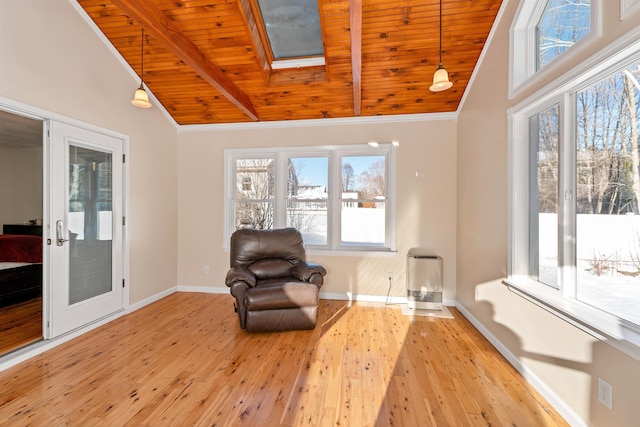 sitting room with wood ceiling, vaulted ceiling with skylight, and light hardwood / wood-style floors