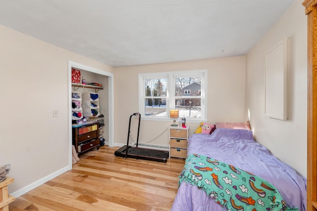 bedroom with a closet and light hardwood / wood-style floors