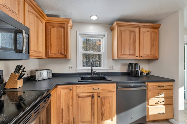 kitchen featuring black appliances, sink, and a textured ceiling