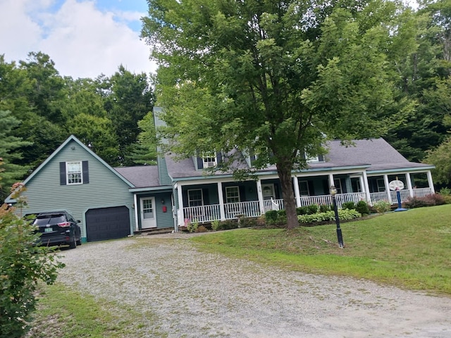 view of front facade with a garage, covered porch, and a front yard