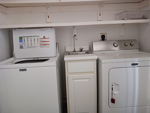 laundry room with cabinets, washer / dryer, and sink