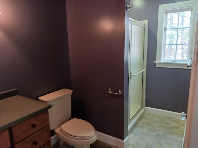 bathroom with vanity, toilet, and walk in shower