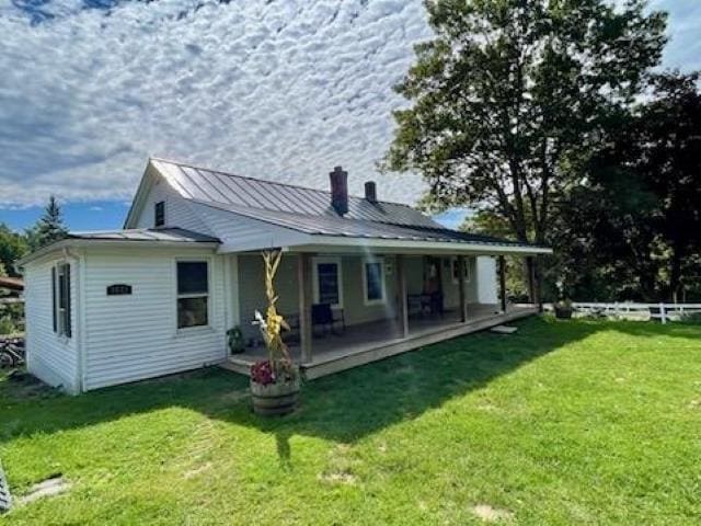 rear view of property with a lawn