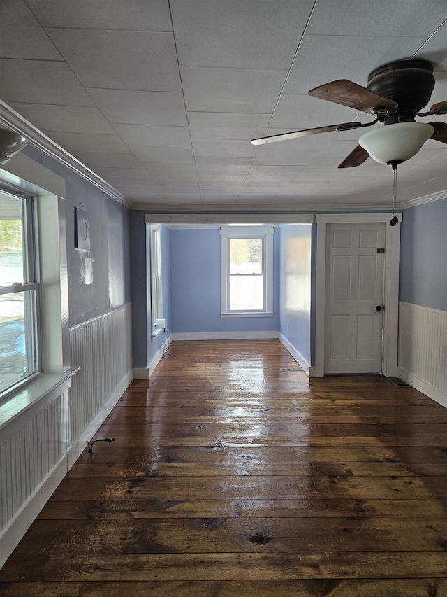 unfurnished room with ceiling fan, dark wood-type flooring, and ornamental molding