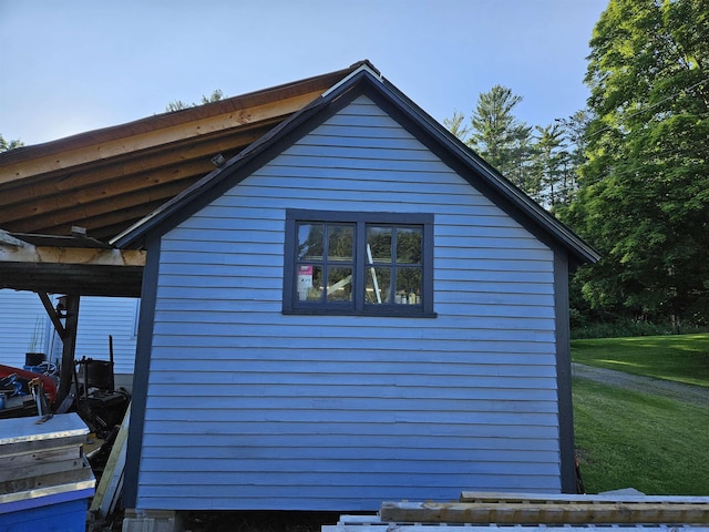 view of side of property with a yard