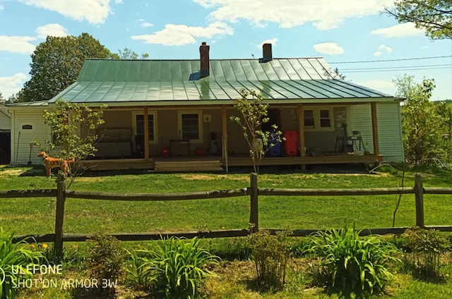 rear view of property with a yard