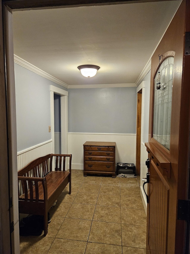 hallway featuring tile patterned floors and ornamental molding