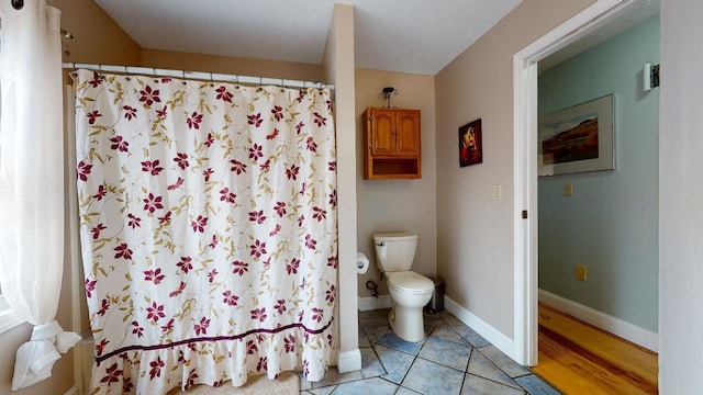 bathroom with hardwood / wood-style floors and toilet