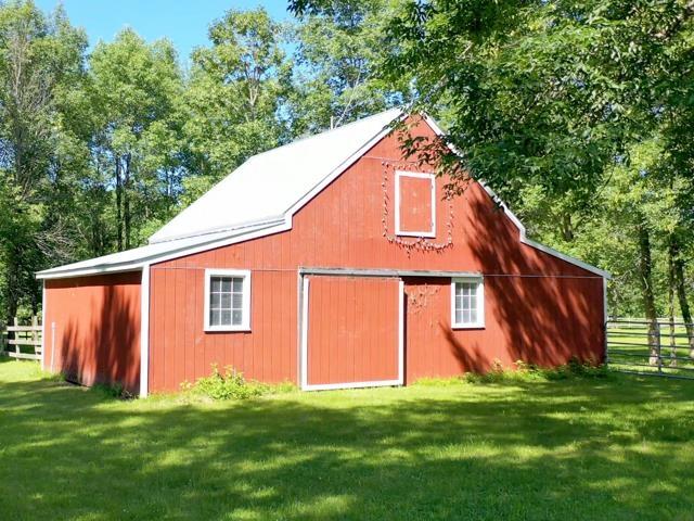 view of outbuilding featuring a lawn