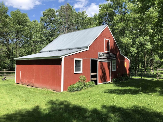 view of outbuilding with a lawn