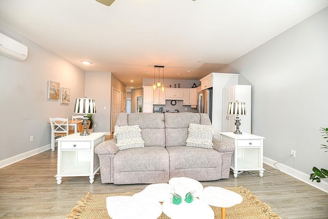 living room featuring light hardwood / wood-style floors and a wall mounted AC