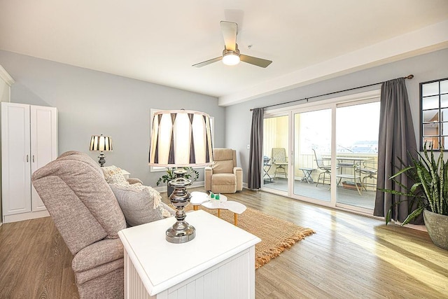 living room with ceiling fan and light hardwood / wood-style floors