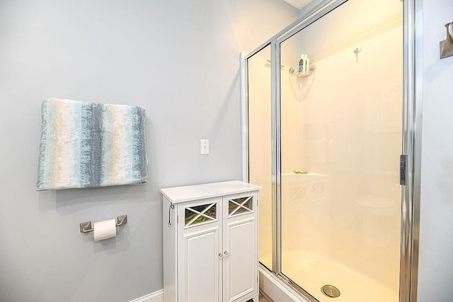 bathroom featuring a shower with door