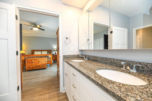 bathroom with ceiling fan, vanity, and hardwood / wood-style flooring