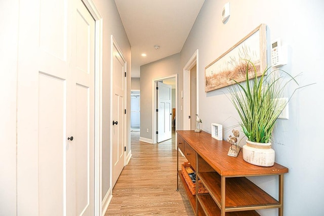 hall with light hardwood / wood-style floors