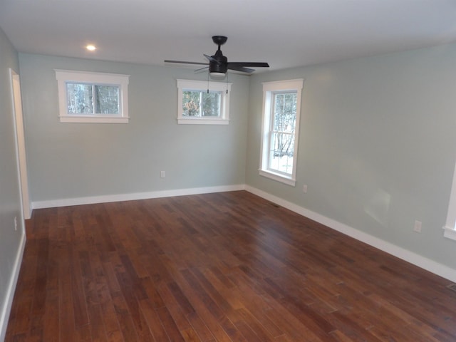 spare room with ceiling fan and dark hardwood / wood-style flooring