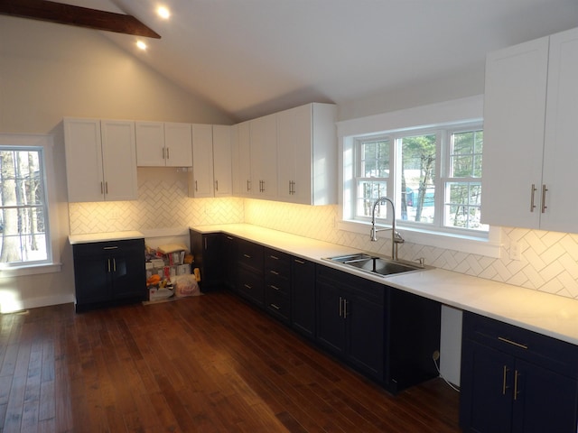 kitchen with dark hardwood / wood-style flooring, sink, decorative backsplash, and white cabinets