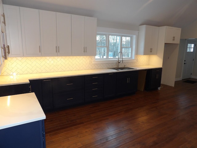 kitchen featuring white cabinetry, sink, dark hardwood / wood-style flooring, and decorative backsplash