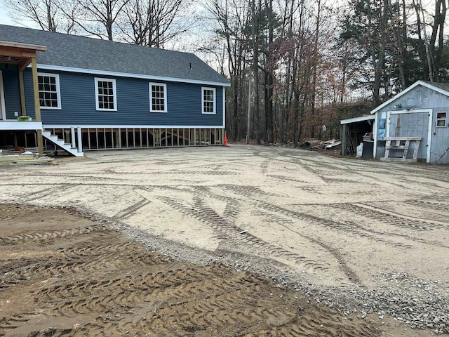 view of side of home featuring a shed