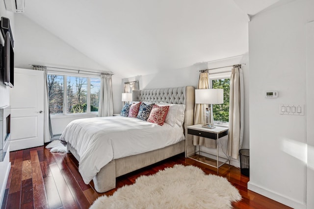 bedroom featuring dark hardwood / wood-style flooring, lofted ceiling, and multiple windows