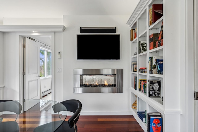 home office with baseboard heating and dark wood-type flooring