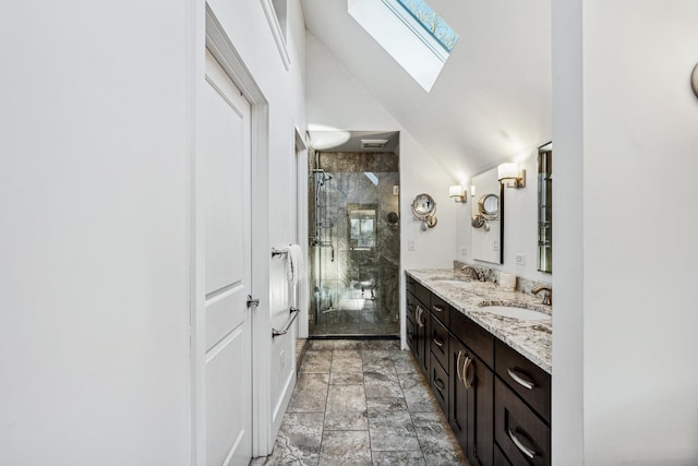 bathroom with vanity, lofted ceiling with skylight, and a shower with door