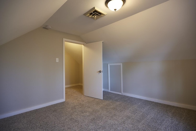 additional living space with carpet floors and vaulted ceiling