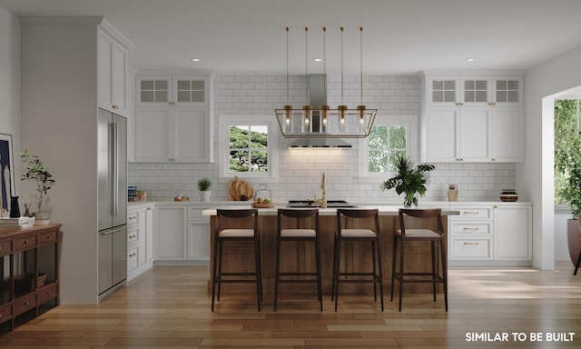 kitchen with plenty of natural light, a center island, and white cabinetry