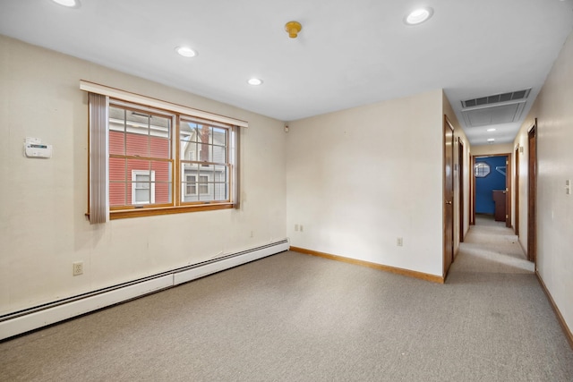 spare room featuring baseboard heating and light carpet