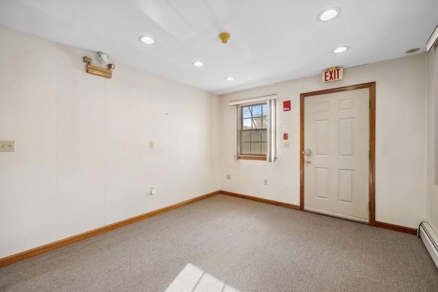 carpeted empty room featuring a baseboard radiator