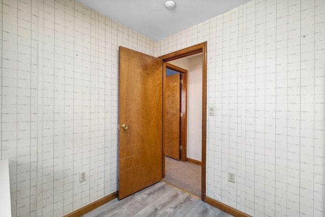 corridor with light hardwood / wood-style flooring