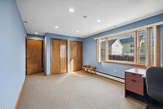 unfurnished office featuring light colored carpet and a baseboard radiator