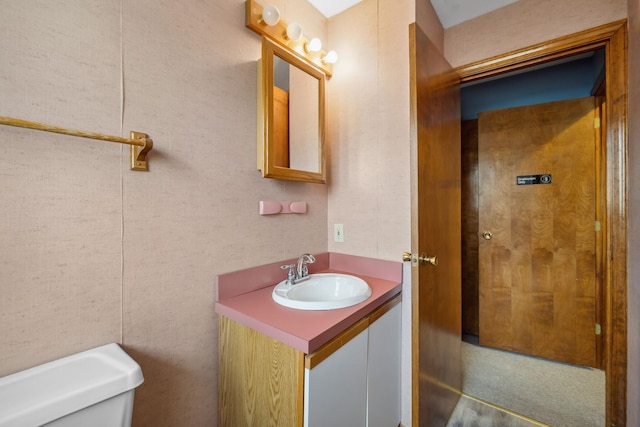 bathroom featuring vanity and toilet