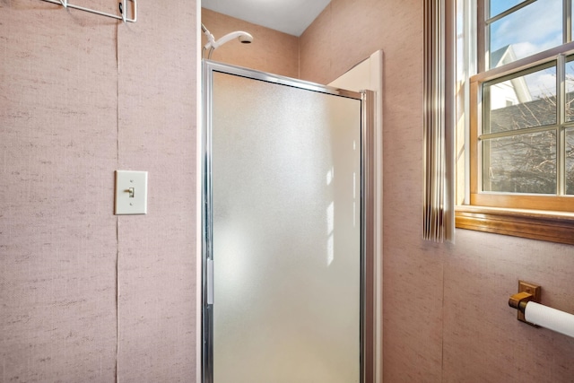 bathroom with a shower with shower door