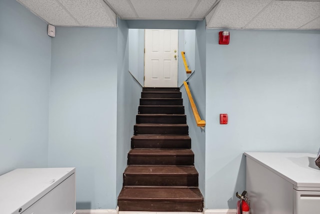 stairway with a paneled ceiling