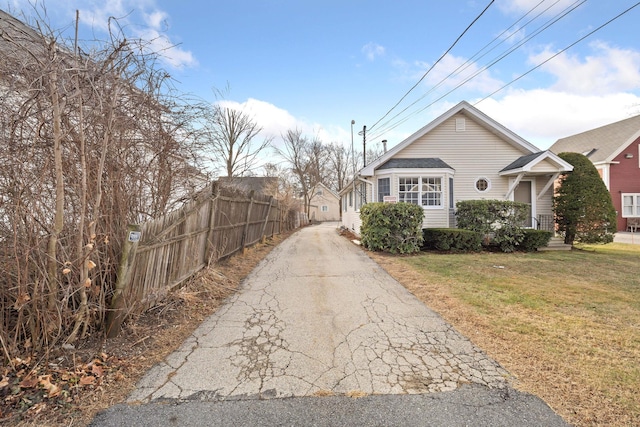 view of property exterior featuring a lawn