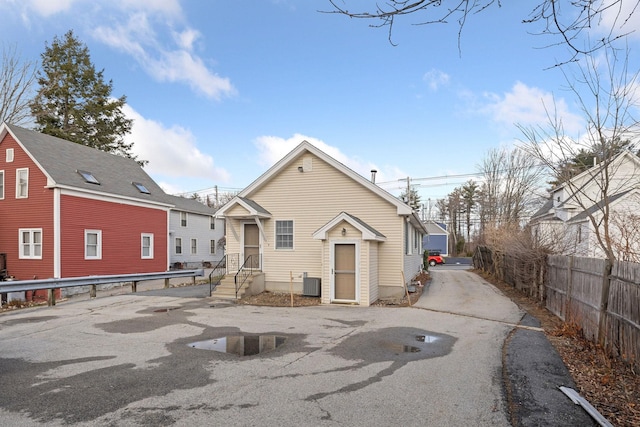 rear view of property with central AC unit