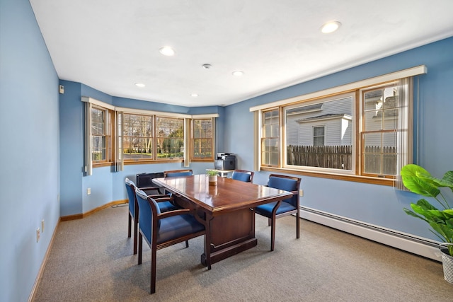 carpeted dining room featuring a baseboard radiator